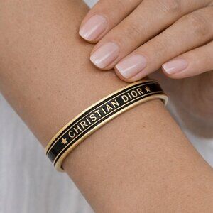 Cuff bracelet with black border highlights open ended. brand new without tags.